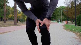Man Having Painful Knee During Running Exercise Inside Park With Trees In Background Body Condition Knee Pain Joint Ligament Problem Knee Pain For Outdoor Exercise - Powered by Shutterstock - Get 15% off with code: PIKWIZARD15