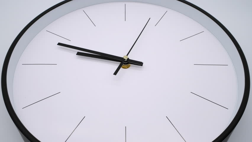 The clock ticking on a white background, in the style of time-lapse video.