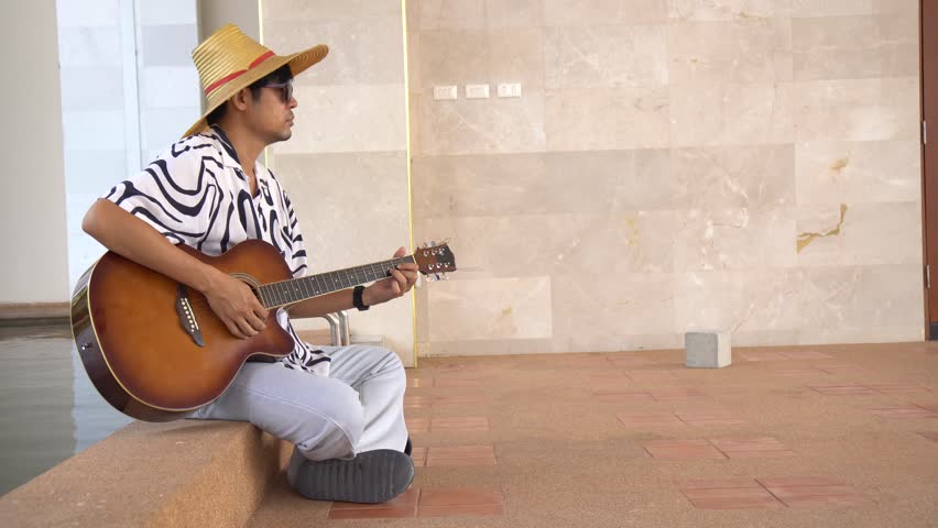 Man playing acoustic a guitar