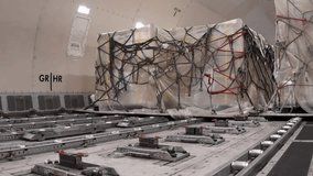 view inside the main deck cargo compartment on a converted wide-body freighter aircraft. Cargo Plane Being Loaded. Global freight transportation concept. Interior of the airplane cargo. - Powered by Shutterstock - Get 15% off with code: PIKWIZARD15