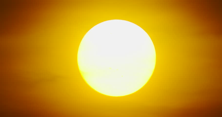 Amazing time laps Beautiful Clear Big sun Sunset Close-up. Big Red Hot Sun in Warm Air Distortion Above Horizon Seamless. 4K DCI 4096x2160p.