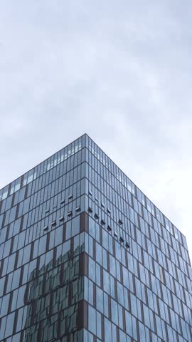 A tall office building with a glass curtain wall.