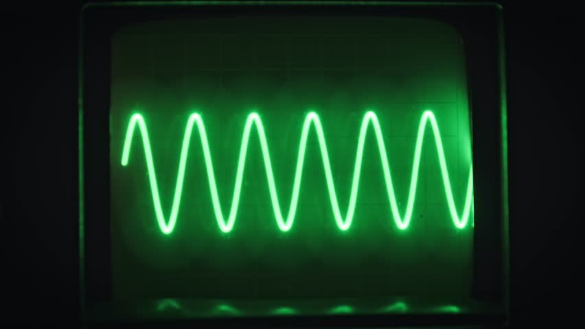 Green sine wave pattern dances on a vintage oscilloscope screen against a dark backdrop. Perfect for tech and science visuals.