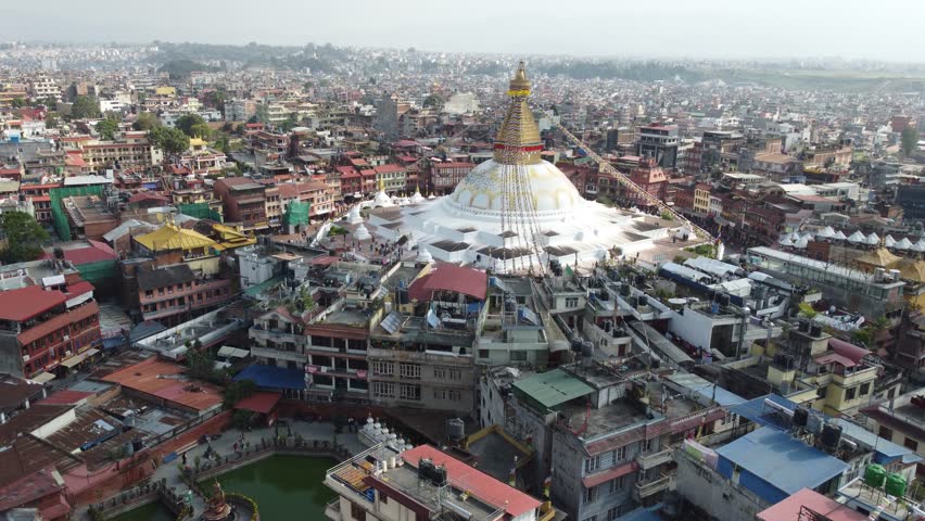 Aerial view of Boudhanath Stupa, a UNESCO World Heritage Site in Kathmandu, Nepal. This iconic Buddhist temple is renowned for its massive white dome and peaceful ambiance, making it a spiritual hub.