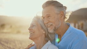 Beautiful happy senior couple dating at the seaside during summertime - Mature married couple in love bonding outdoors at the beach, concepts about elderly lifestyle, relationship and quality of life - Powered by Shutterstock - Get 15% off with code: PIKWIZARD15
