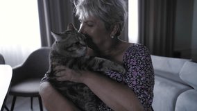 Cheerful happy middle aged female holding furry kitty cat in arms, Woman bonding with cat pet  - Powered by Shutterstock - Get 15% off with code: PIKWIZARD15