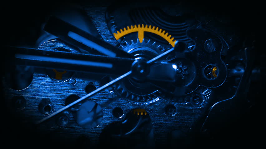 Dark background. Mechanism of watch close-up tinted blue. Some details tinted in