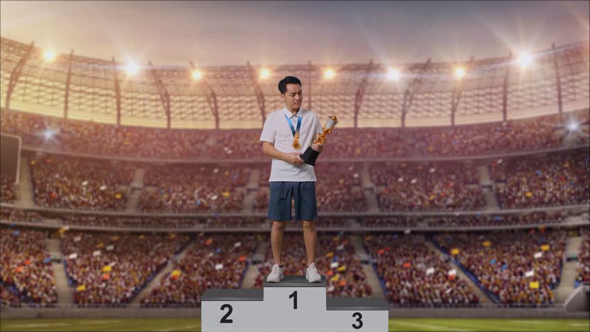 Full Body Of Asian Man With A Gold Medal And Trophy Making Shh Gesture Telling It Is A Secret To Win As The First Winner At The Stadium