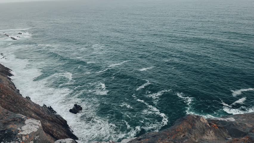 Over sight of ocean waves from a cliff in Mosselbay in South Africa