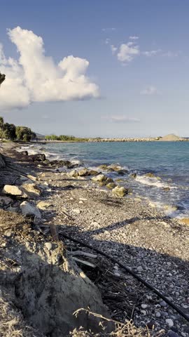 Coastal View With Rocky Shore and Water Under Clear Sky During Late Afternoon