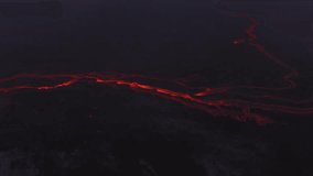 Mesmerizing aerial view of glowing lava channels carving their path through Iceland's volcanic landscape at night - Powered by Shutterstock - Get 15% off with code: PIKWIZARD15