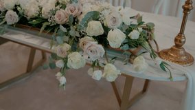 Elegant floral centerpiece with roses and greenery on a decorated table indoors - Powered by Shutterstock - Get 15% off with code: PIKWIZARD15