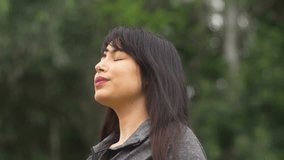 Thoughtful woman looking up while embracing the peaceful atmosphere of nature. Calm and content expression as she enjoys a quiet moment outdoors in a serene environment. - Powered by Shutterstock - Get 15% off with code: PIKWIZARD15