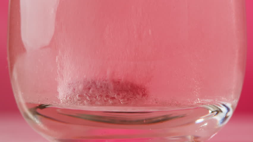 Effervescent tablet vitamin C aspirin nutritional supplements in glass with yellow carbonated water, sport medication, healthy morning. Healthy vitamins D drugs