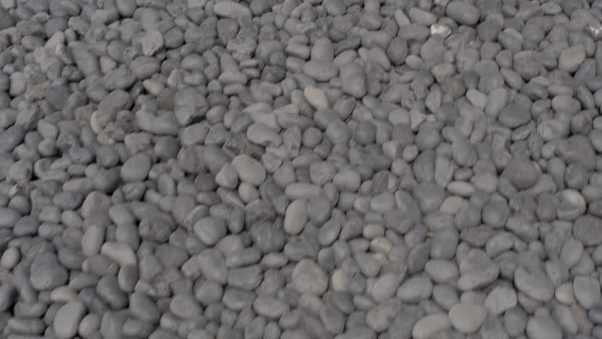 Grey Rocks Scattered Along the Oregon Coast Shore Line at Yaquina Head Lighthouse Park. Close Up of Rocky Pebbles on Waterfront.