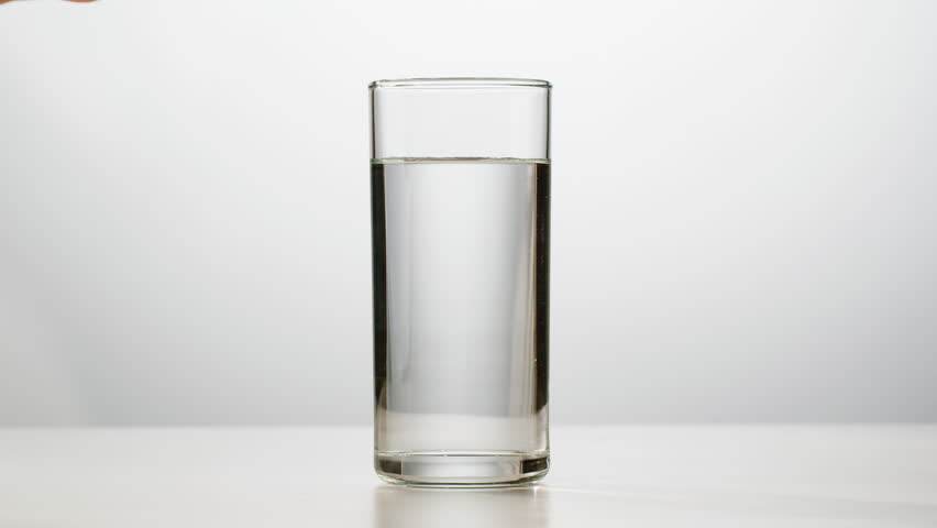 Effervescent tablet vitamin C aspirin nutritional supplements in glass with yellow carbonated water, sport medication, healthy morning. Healthy vitamins D drugs