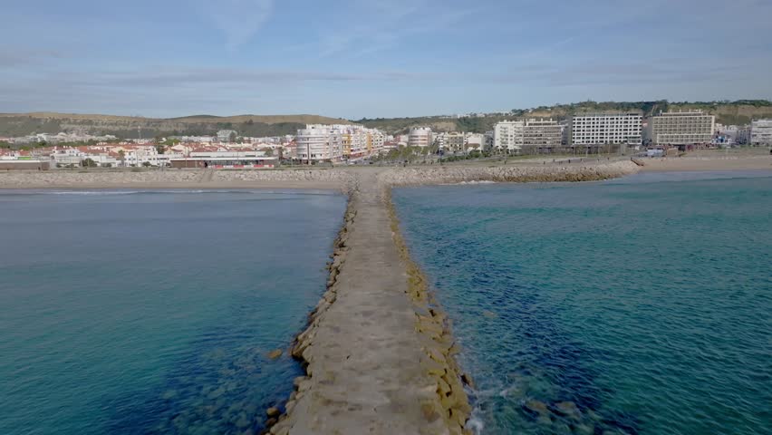 A wave breaking pier in Costa Da Caparica.