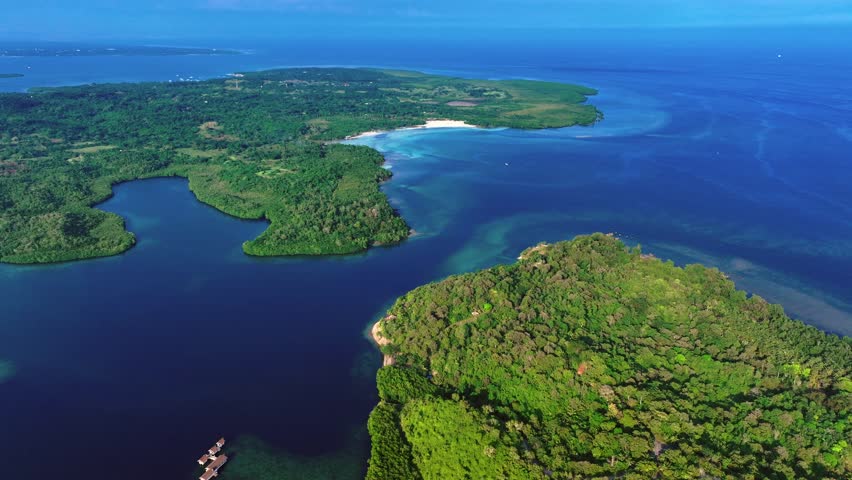 Green islands of Philippines, Palawan, Puerto Princesa. Turtle bay with blue and turquoise water and sandy beach. Aerial wide shot.