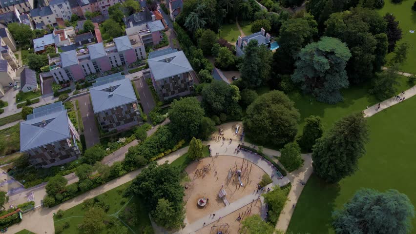 Sideway upwards drone movement about the Parc du Thabor spiral garden and its closest environment, Rennes, France.