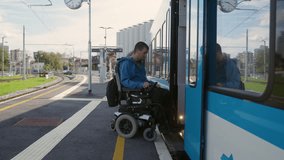 Man with physical disability, an electric wheelchair user entering a train, handheld shot. Accessible travel and inclusive transportation concepts. - Powered by Shutterstock - Get 15% off with code: PIKWIZARD15