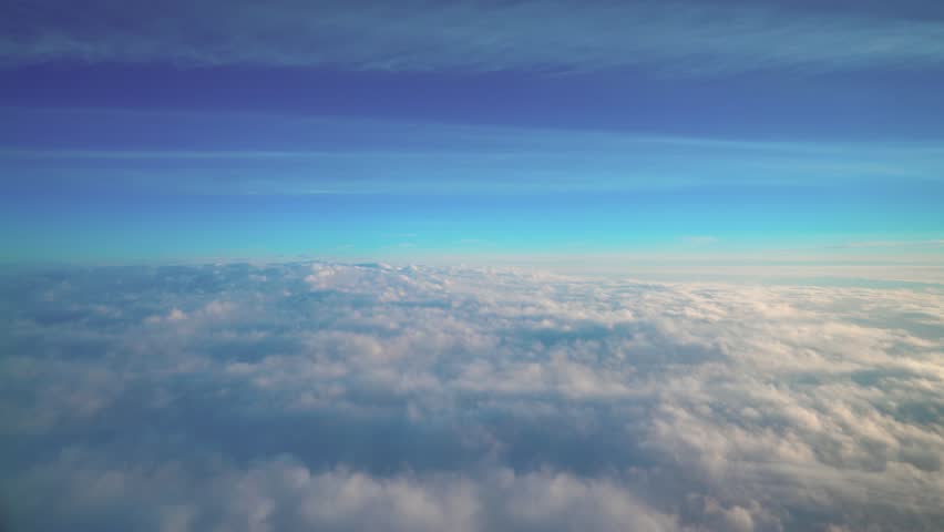 An aerial perspective showcasing soft clouds and a vast sky. Perfect for themes of air travel, serenity, and natural beauty, offering a calm and picturesque view of the atmosphere above.