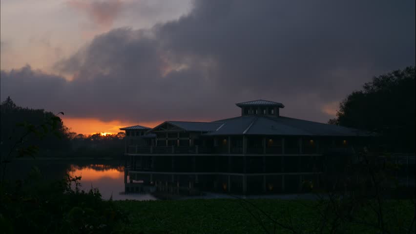 Green Cay Wetlands Nature Preserve, Boynton Beach, Florida - Sun Rises Over the Lake Behind the Visitor Center Beneath a Colorful Cloudy Sky in a Time-Lapse