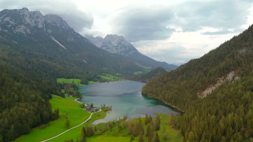 Hintersteiner See mountain lake in Austria near town of Kufstein, aerial view in summer at sunset in cloudy weather. Hintersteiner See in Oesterreich in der Nahe der Stadt Kufstein Luftaufnahme. 