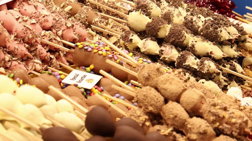 Chocolate covered fruits on the Christmas market stall, close up detail