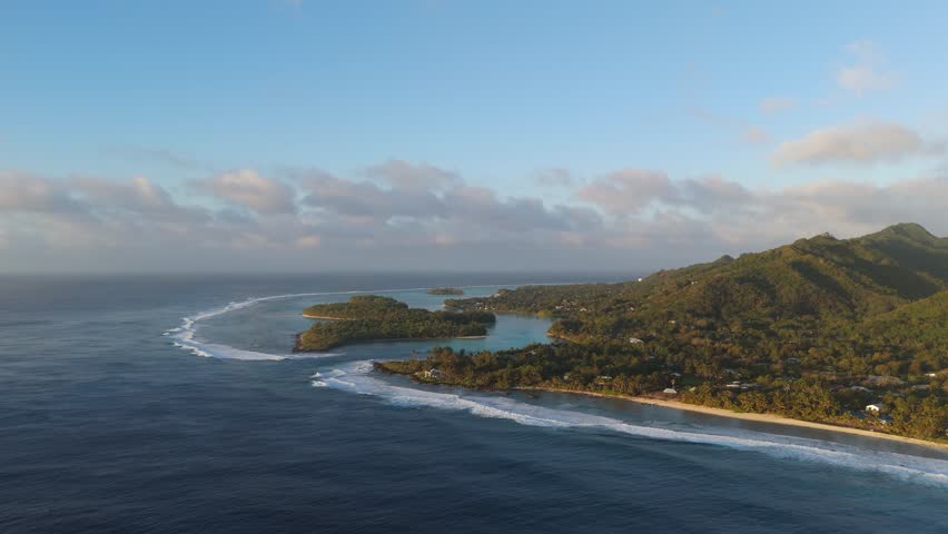Panoramic drone footage of one of the Cook Islands, Rarotonga in the early morning at sunrise.
