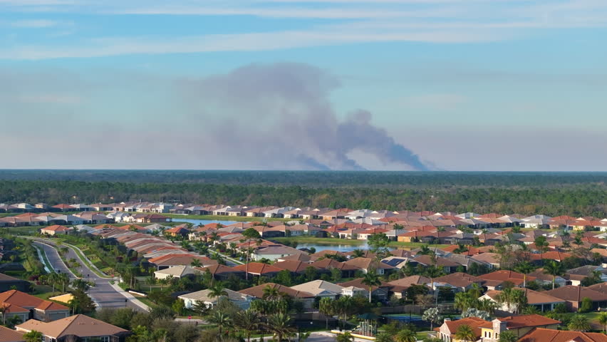 Air pollution with toxic smoke from prescribed forest fire close to rural neighborhood in Florida, USA