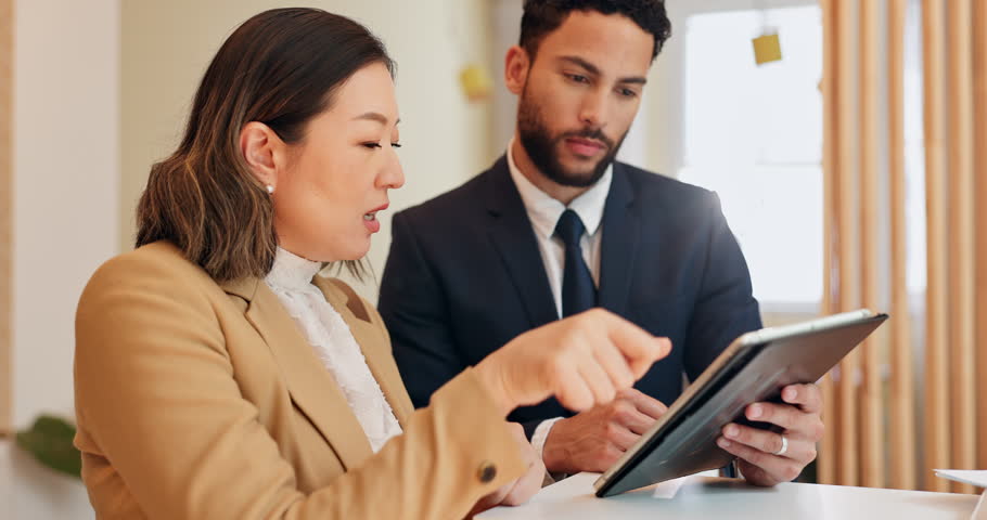 Discussion, tablet and hotel receptionist with woman for accommodation booking on business trip. Conversation, technology and man concierge with guest for hospitality service for corporate travel.