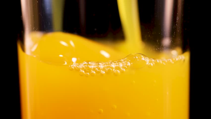 Orange juice being poured into a glass