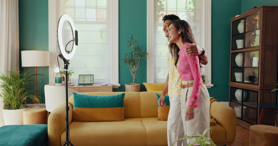 Live streaming, ring light and high five with couple in house for influencer, social media and content creator. Audience engagement, notification and success with people for vlog and broadcast