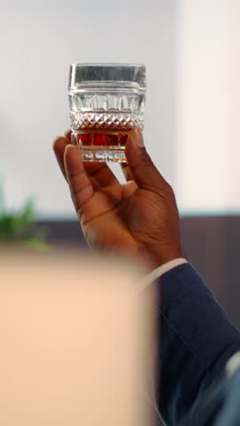 Vertical Video Two diverse high society members in a private gentlemen club discussing career advancement and opportunities while enjoying a sophisticated whiskey experience. Old money billionaires