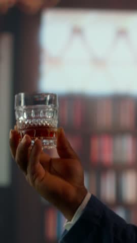 Vertical Video Multiethnic entrepreneurs talk business strategy over whiskey in a luxurious social club, capturing the essence of upper class entertainment and professionalism. High society members