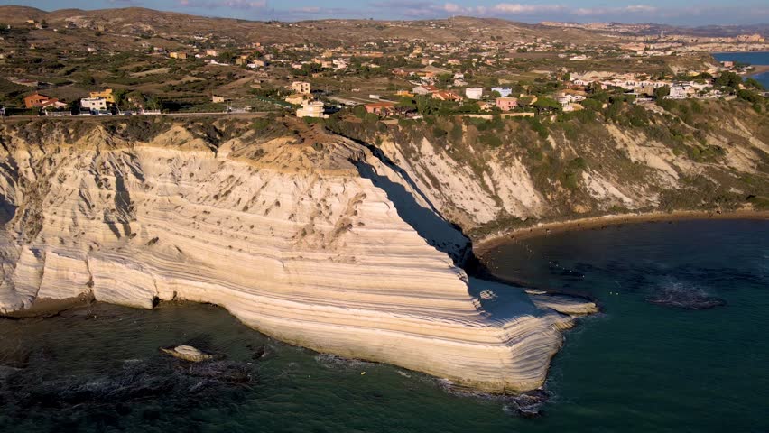 Witness the breathtaking coastline of Sicily, with its striking white cliffs cutting into the turquoise sea, Scala dei Turchi (Italy) - The very famous white rocky cliff on the coast