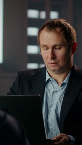 Vertical Video African american secret service agent in a classy headquarters library, briefing each other on critical mission case details over whiskey glasses. Professional intelligence bureau spies