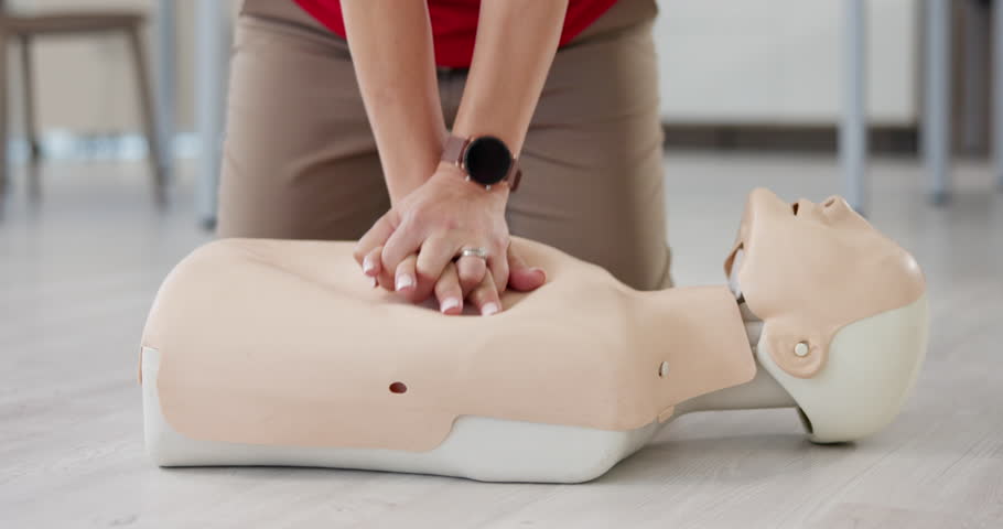 Person, hands or dummy with CPR for first aid training or class at emergency healthcare practice on floor. Closeup, trainer or paramedic with mannequin for life saving lesson or rescue practical