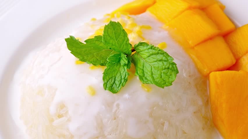 Mango sticky rice on a white plate