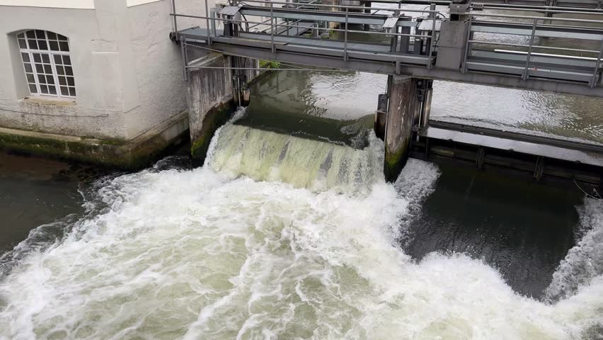 dam water lock on a river is opened 4k