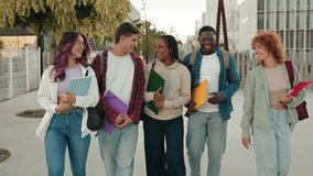 Cheerful young multiethnic college students talking and walking after classes on University campus  - Powered by Shutterstock - Get 15% off with code: PIKWIZARD15