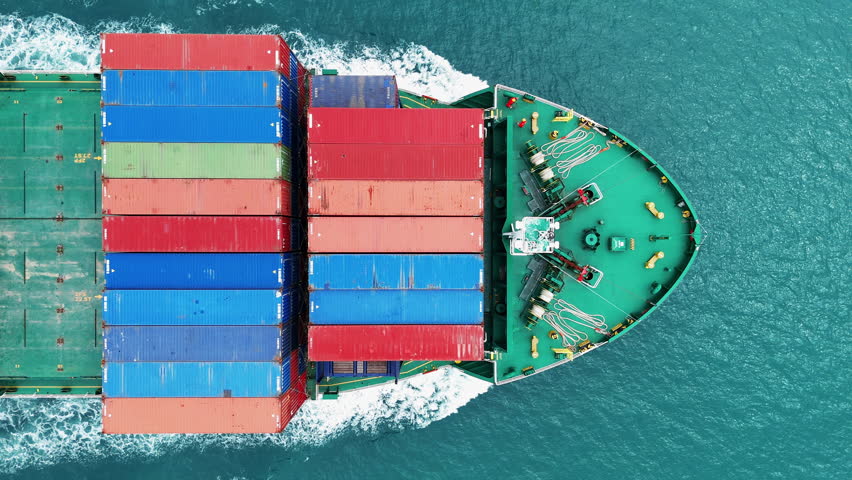 Aerial top view of cargo ship carrying container and running for export cargo yard port to custom ocean concept technology transportation , customs clearance