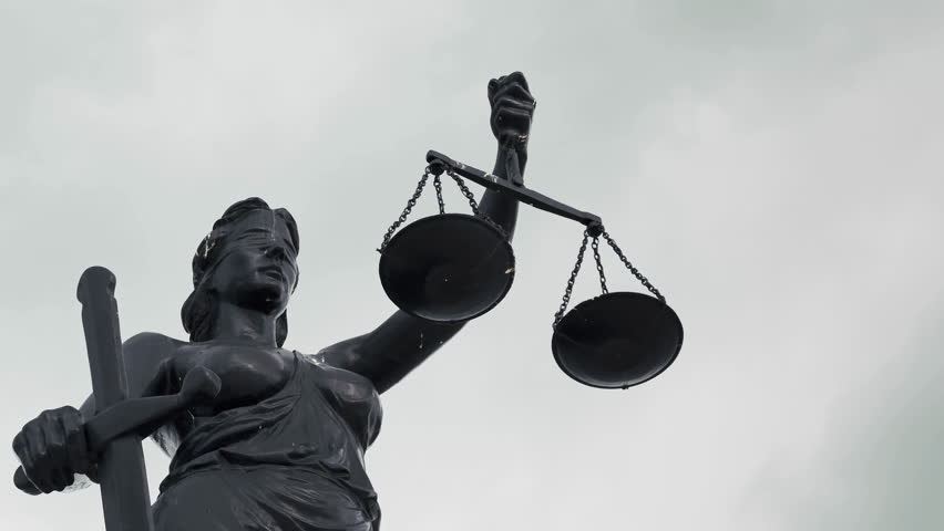 A Sculpture Art of Lady Justice Statue in Cloudy Rainy Day