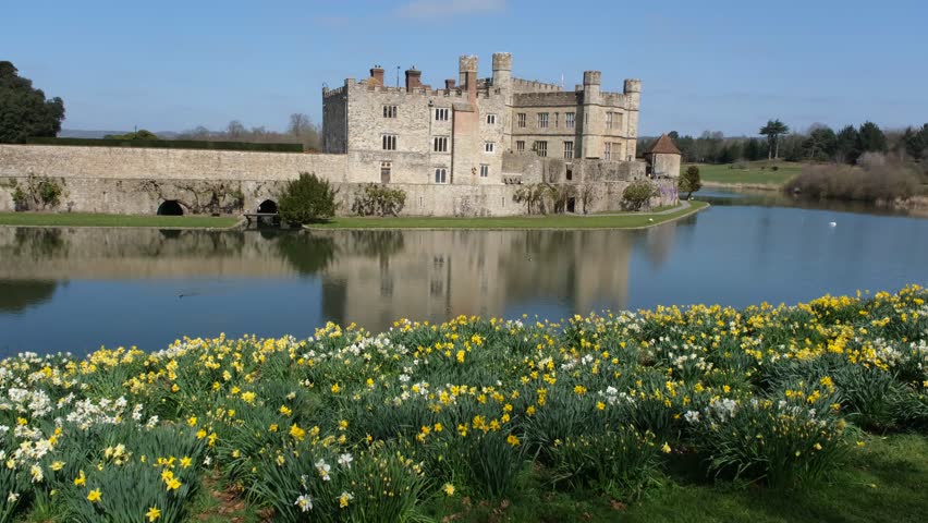  View of Leeds Castle in Kent, UK. Leeds Castle, England, reflection, spring sunny day, with flowers blooming. 