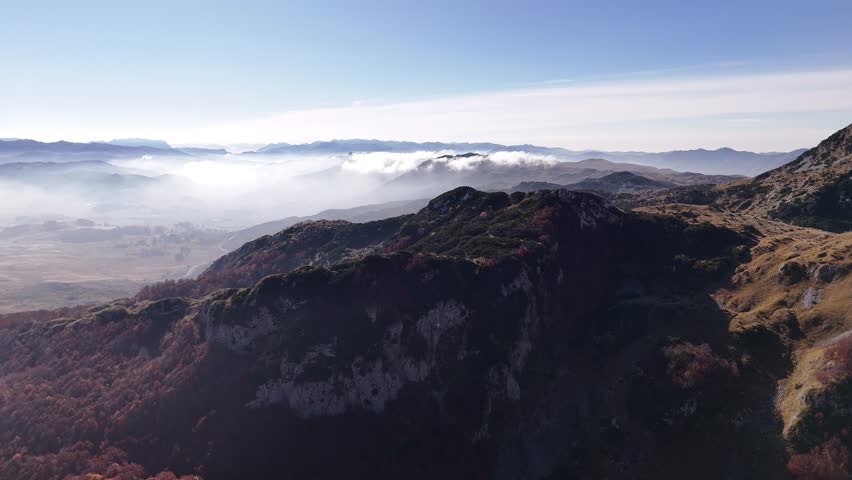 Majestic mountain landscape unveiling layers of mist and light across peaks