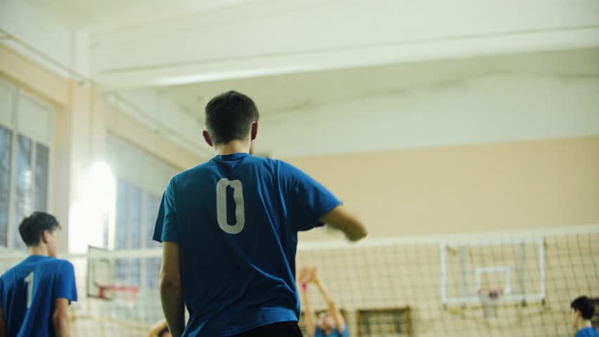 Close-up of the back of a sports player wearing a uniform with the number “0”. Athletic look, sporty style and the moment of waiting for the game in the gym.