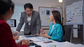 Manager standing and explaining a new strategy to colleagues during a business meeting in a professional office setting - Powered by Shutterstock - Get 15% off with code: PIKWIZARD15