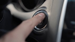 Unrecognizable male driver pushing start ignition button switch in modern luxury car. Close up of adult person pressing engine start button by finger inside car salone. Concept of new car. - Powered by Shutterstock - Get 15% off with code: PIKWIZARD15