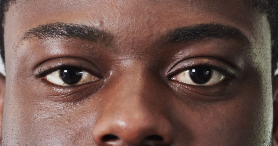 Man's eyes focusing intently, capturing thoughtful expression in close-up shot. Concentration, intensity, contemplation, portrait, detail, emotion