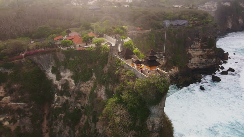 
Drone shot of the Pura Luhur Temple in Uluwatu, Bali. Stunning view of an Hindu temple perched on the edge of a cliff.